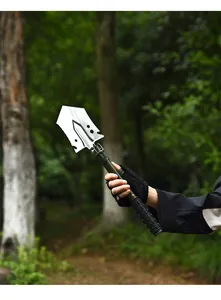 Action shot of a portable multifunctional outdoor entrenching tool in a forest setting