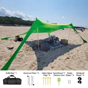Portable green Lycra beach tent canopy with aluminum poles and complete accessory kit