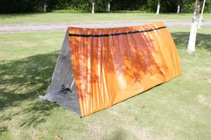 Outdoor emergency survival tent made of thickened PE thermal insulation material in orange.