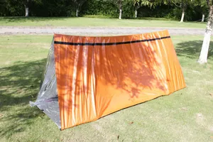 Orange PE thermal emergency tent set up on a lawn for outdoor survival details.
