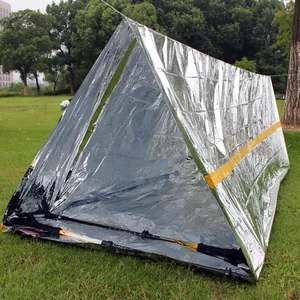 Professional silver emergency thermal tent shelter set up outdoors for survival use