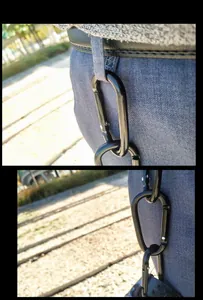Detailed view of black D-shaped aluminum alloy carabiners attached to a belt loop