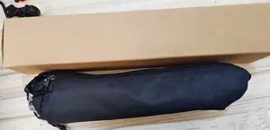 Detail view of the black durable carrying bag and sturdy cardboard box for outdoor camping rack