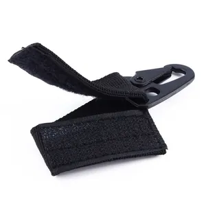 Detail of black tactical nylon webbing strap with eagle beak metal carabiner hook.