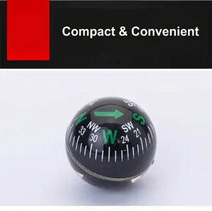 Close-up macro view of a 28mm portable spherical plastic compass for outdoor hiking