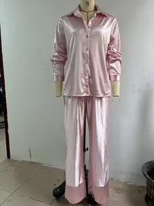 Elegante conjunto de pijama de dos piezas de satén rosa con mangas largas en maniquí