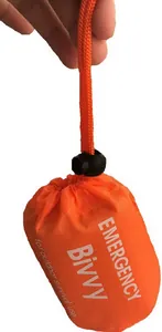 Portable orange emergency bivvy sleeping bag in compact drawstring storage sack for camping