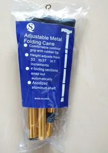 Close-up of golden aluminum folding walking cane inside clear plastic packaging