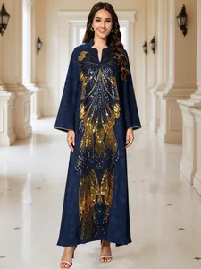 Detail of elegant navy kaftan dress with gold butterfly sequin embroidery