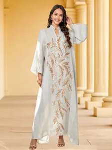 Full-length view of an elegant gray banquet dress featuring golden sequin leaf embroidery