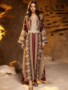 Elegant burgundy kaftan dress with intricate gold embroidery and matching waist belt.