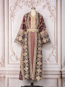 Detailed view of ornate gold embroidery on a Malaysian-style two-piece kaftan set.