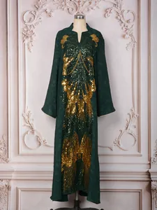 Detailed view of dark green kaftan dress with gold butterfly sequin embroidery