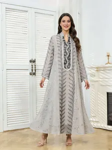 Close-up detail of long sleeve ethnic dress with mesh sequin beadwork and embroidery