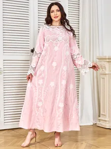 Full-length view of pink dress with exquisite white floral embroidery and lace accents.