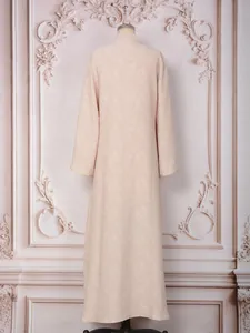 Elegant beige long-sleeved evening gown with floral jacquard texture shown from the back.