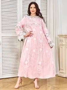 Elegant pink maxi dress featuring intricate white floral embroidery and lace cuffs