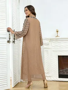 Detailed back view of an ethnic mesh long dress with leaf pattern embroidery on sleeves.