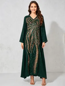 Detailed front view of an elegant dark green maxi dress with gold sequin patterns.