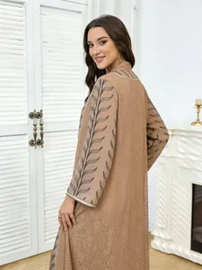 Close-up detail of the brown ethnic mesh long dress featuring leaf embroidery and sequins