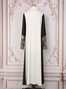 Vue arrière élégante d'une robe longue bicolore avec des poignets perlés et pailletés