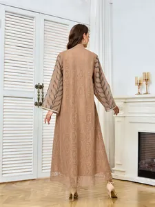 Detailed back view of a mesh maxi dress featuring intricate leaf embroidery on the sleeves