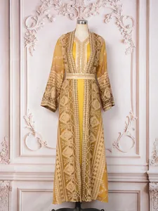 Detailed embroidery on elegant yellow two-piece Malaysian style robe dress
