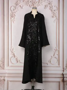 Detail showing heavy butterfly sequin embroidery on an elegant black party dress.