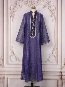 Full-length detail of a purple ethnic mesh dress with exquisite embroidery and sequins