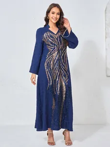 Detail view of an elegant navy ethnic dress with heavy golden sequin wing appliqué.