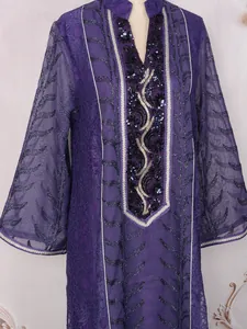 Close-up of ethnic purple mesh dress with intricate sequin and beadwork embroidery.