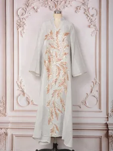 Elegant white maxi dress with gold sequin leaf pattern embroidery for formal banquet.