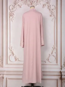 Vue arrière d'une robe longue rose poudré élégante ample avec poignets perlés