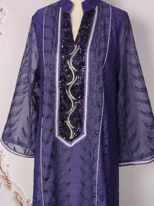 Close-up detail of ethnic mesh dress featuring intricate sequin and bead embroidery