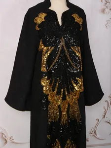 Detailed view of heavy gold and black sequin butterfly embroidery on black dress