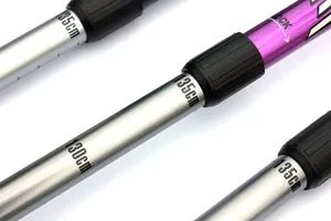 Close-up of aluminum trekking pole showing height scale 130cm-135cm and lock mechanism