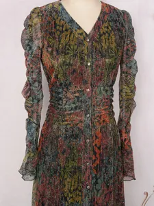 Close-up of floral pleated dress with V-neck, ruched waist and subtle shimmering detail