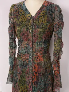 Close-up of elegant pleated floral evening dress with sparkling details.