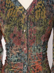 Macro view showing the pleated dress fabric with floral patterns and sparkly hot rhinestones