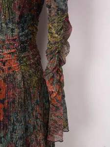 Macro detail of metallic floral pleated dress featuring elegant ruffled sleeve design