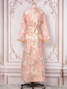 Detail view of elegant pink gold floral jacquard party dress with beaded sleeves