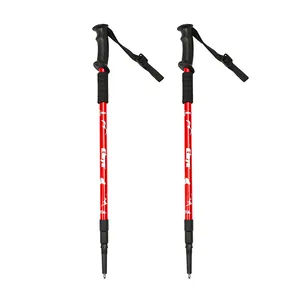 Pair of professional red aluminum trekking poles with ergonomic black handles and straps