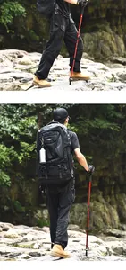 Adjustable red aluminum alloy trekking pole used in rugged outdoor mountain terrain