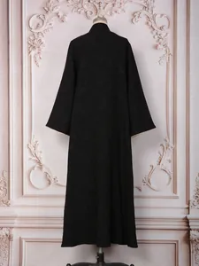 Back view of elegant black long-sleeved evening gown featuring detailed floral jacquard