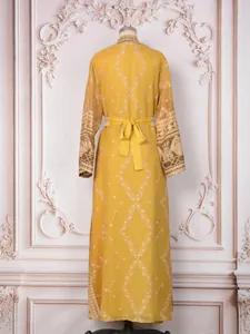 Back view of yellow Malaysian style dress with elegant geometric embroidery on mannequin