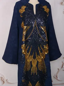 Close-up view of intricate heavy gold sequin butterfly embroidery on navy party dress