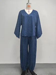 Elegant two-piece navy blue polka dot set with long batwing sleeves and jogger pants.