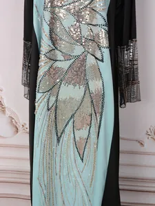 Vue détaillée des appliques de paillettes sur cette robe longue ethnique