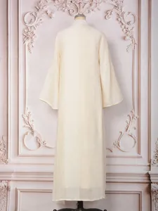 Back view of an elegant cream off-white maxi dress with flared sleeves and vertical stripes