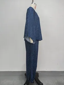 Detailed side view of a navy blue polka dot lounge set featuring batwing sleeves and tapered pants.